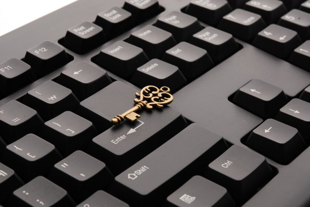 A photo of an antique brass key placed on top of a keyboard to signify keywords