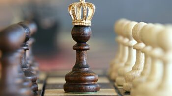 A photo of a chess piece wearing a crown to signify that content is king