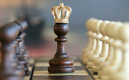 A photo of a chess piece wearing a crown to signify that content is king