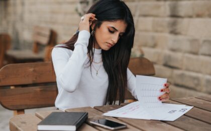 A lady sitting at a table planning out her tasks