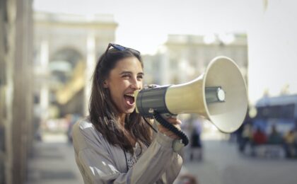 Lady calling out a message on a loudspeaker