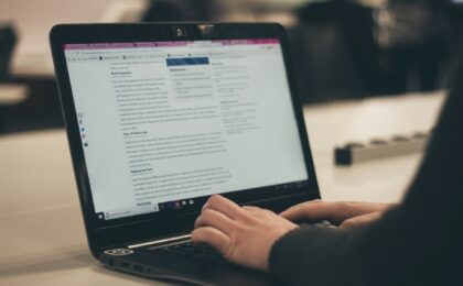 A blog post being written on a laptop that is split into paragraphs with subheadings